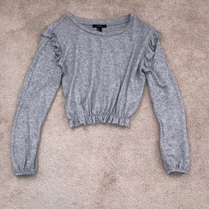 *cropped, grey sweater.*